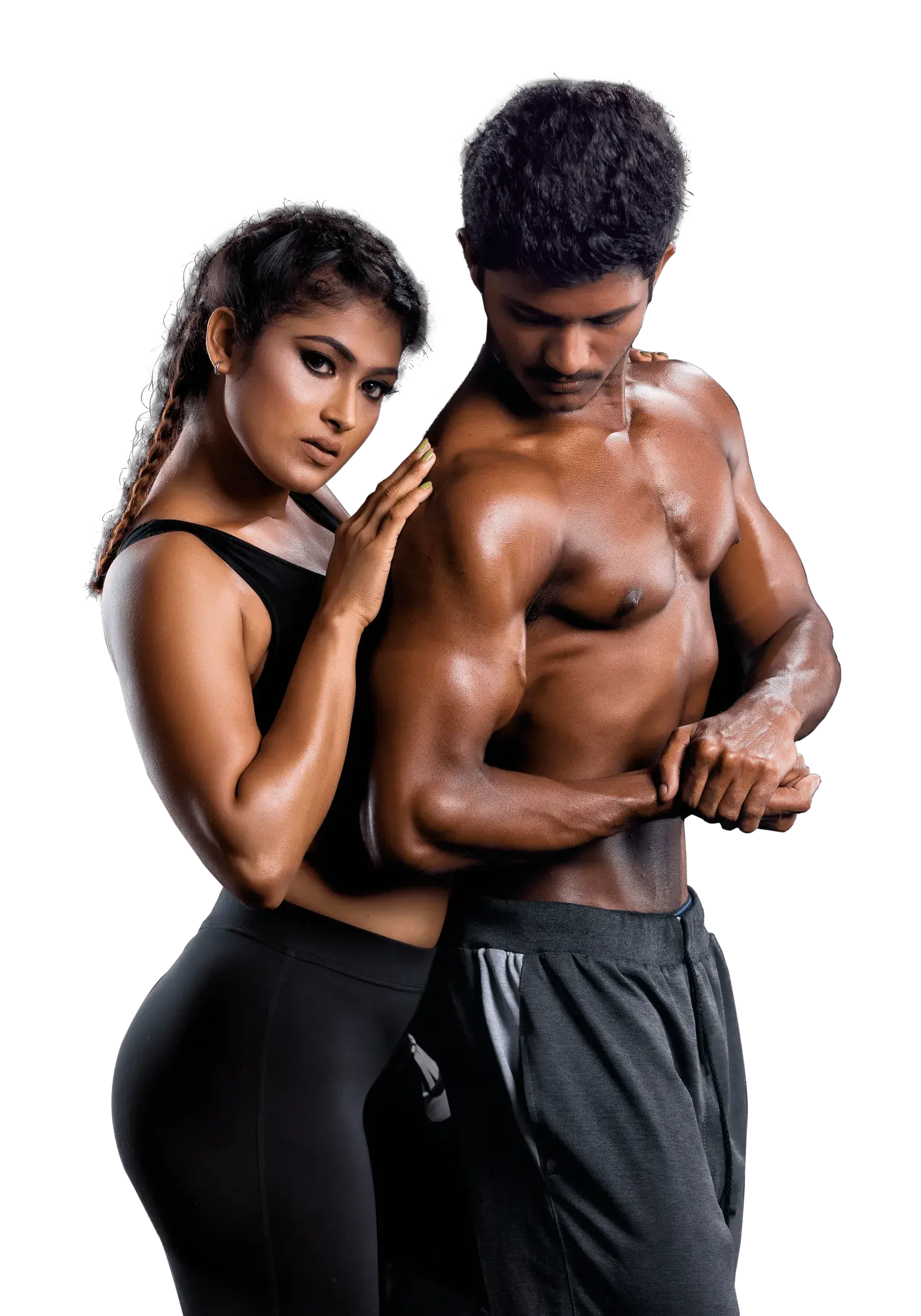 A woman rests her hands on the shoulder of a muscular man as he looks down, both in black training wear